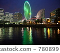 Neon of the Ferris wheel reflected on the surface of the water 780899