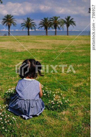 Girl picking clover 786917