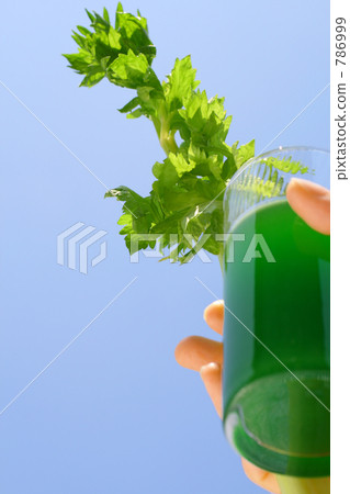 Women's hands and sky with drink (vegetable juice) and celery Women's hands and sky with drink (vegetable juice) and celery 786999