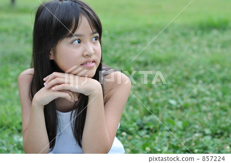 Girl crouching on the lawn 857224