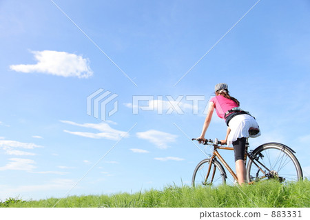 A woman running a bank with a bicycle A woman running a bank with a bicycle 883331