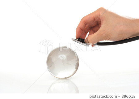 Hand with earth and stethoscope 896018
