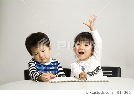 Two people drawing pictures with crayons Two people drawing pictures with crayons 914360