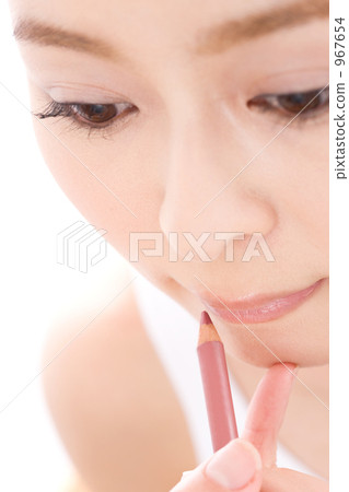 A woman applying lipstick 967654