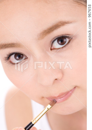 A woman applying lipstick A woman applying lipstick 967658