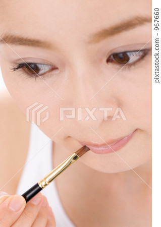A woman applying lipstick A woman applying lipstick 967660