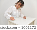 A woman assembling furniture 1001172