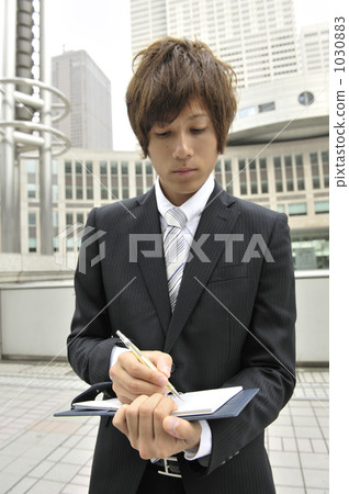 Businessman writing in the system notebook Businessman writing in the system notebook 1030883