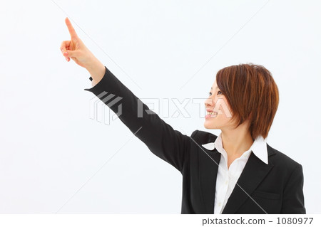 A woman in a suit that points to a hand 1080977