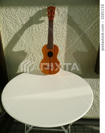 Ukulele on a white table Ukulele on a white table 1085158