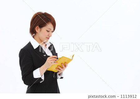 A woman with a suit with a notebook A woman with a suit with a notebook 1113912