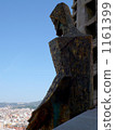 A stone statue overlooking the city of Barcelona 1161399