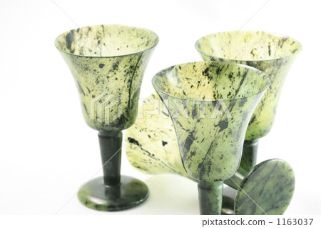 A traditional Chinese craft from Gansu Province, China: a luminous green glass sake cup made from jade (white background) 1163037
