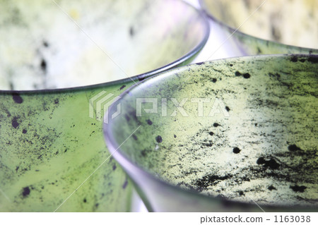 A traditional Chinese craft from Gansu Province, China: a luminous green glass sake cup made from jade (white background) 1163038