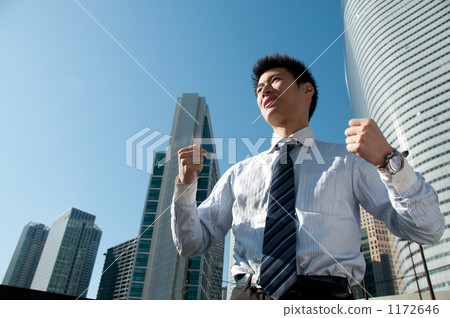 Businessman and skyscraper doing guts pose 1172646