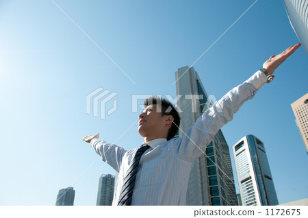 Businessman and a skyscraper deep breathing 1172675
