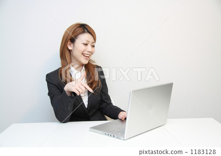 A woman using a computer A woman using a computer 1183128