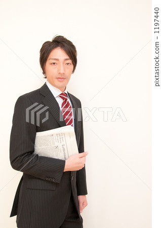 A businessman with a newspaper A businessman with a newspaper 1197440