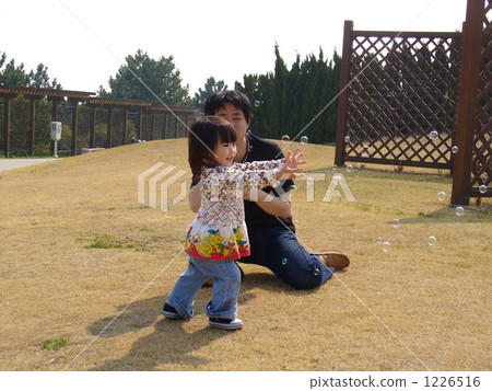 Parents and children playing with soap bubbles Parents and children playing with soap bubbles 1226516
