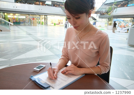 A woman writing a document A woman writing a document 1237990
