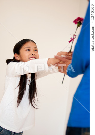 Children and mothers passing carnations Children and mothers passing carnations 1240169