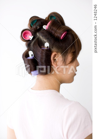 A young woman wearing curlers 1248246