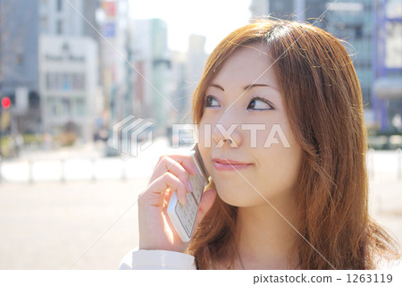 A woman who speaks by telephone on the streets A woman who speaks by telephone on the streets 1263119