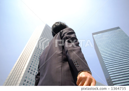 A businessman looking up at the building 1364735