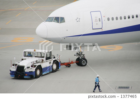 Car towing tractor working at airfield Car towing tractor working at airfield 1377465