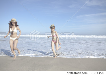 穿著泳衣的女人在波浪上投球 穿著泳衣的女人在波浪上投球 1384358
