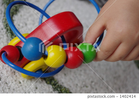 Children's hand playing with wooden toys 1402414