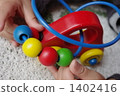 Children's hand playing with wooden toys 1402416