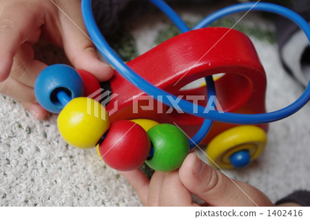 Children's hand playing with wooden toys 1402416