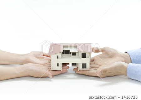 A couple with a housing model A couple with a housing model 1416723