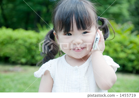 A girl with a smile with a cell phone 1455719