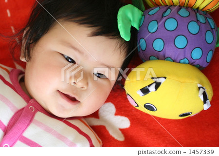 Baby playing with a stuffed toy 1457339