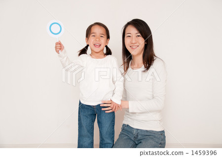 A girl with a round plate and a mother A girl with a round plate and a mother 1459396