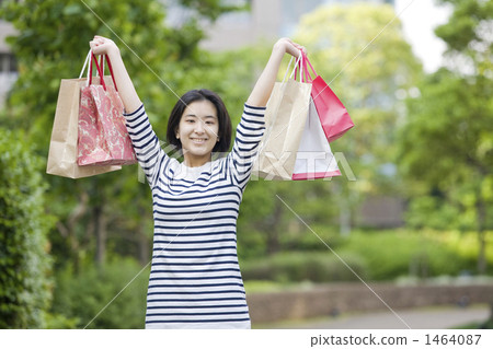 A girl with a smile with a shopping bag A girl with a smile with a shopping bag 1464087