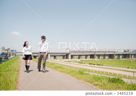A walking high school student couple A walking high school student couple 1485219