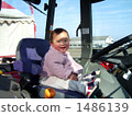 A red cheeky girl riding a red tractor 1486139