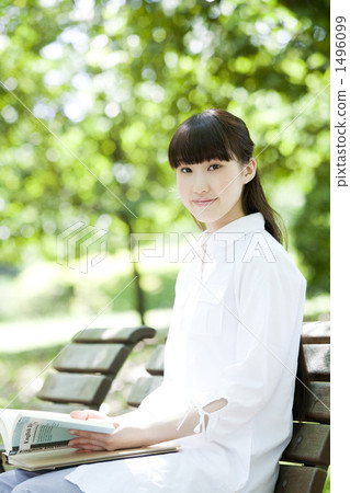 A young woman studying in the park 1496099