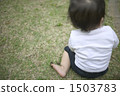 Infant sitting on the lawn 1503783