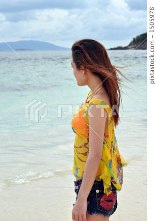 A woman nestling on the beach of Kai A woman nestling on the beach of Kai 1505978