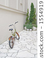 Rusted bicycle nestling in the alley 1554919