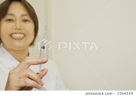 Smiley female doctor with syringe Smiley female doctor with syringe 1564339