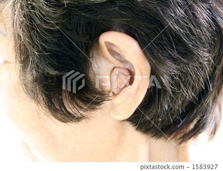Woman wearing ear hole type hearing aid Woman wearing ear hole type hearing aid 1583927