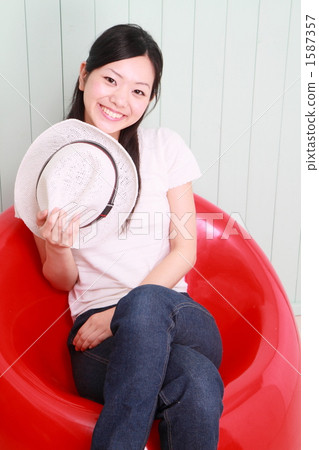 A woman sitting in a red chair A woman sitting in a red chair 1587357