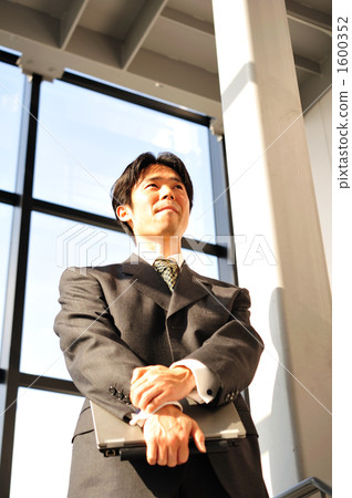 A businessman looking out the window 1600352