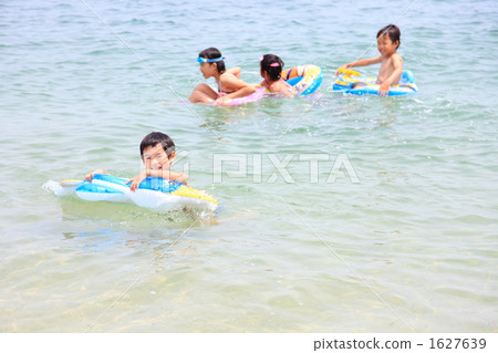 A smiling boy swimming on the float A smiling boy swimming on the float 1627639