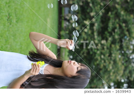 Girls playing with soap bubbles Girls playing with soap bubbles 1639943